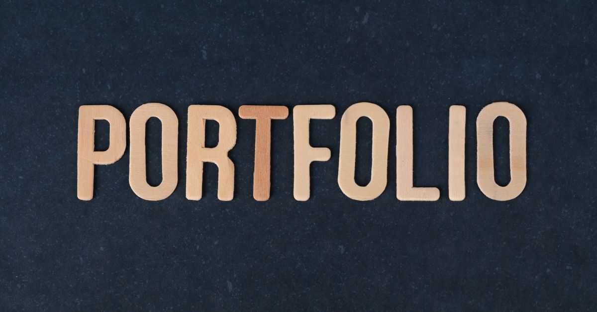 Wooden letters spelling the word 'portfolio' on a textured black background, ideal for creative projects.